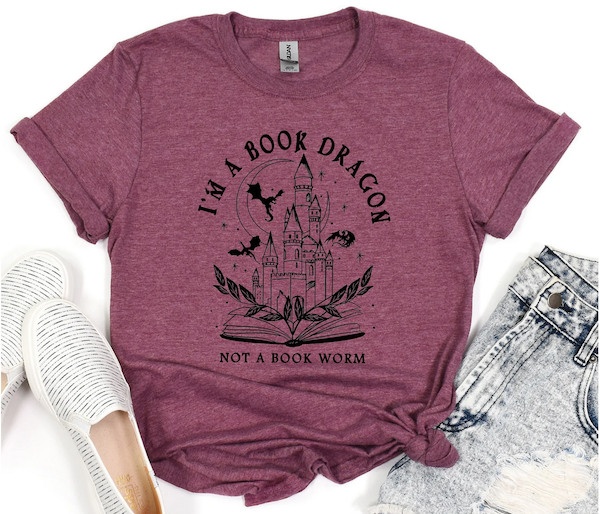 wine color tshirt with a black outline design of a dragon reading that says I'm Not A Bookworm I'm A Book Dragon