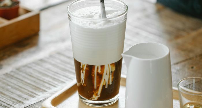 glass of iced coffee with a layer of foam