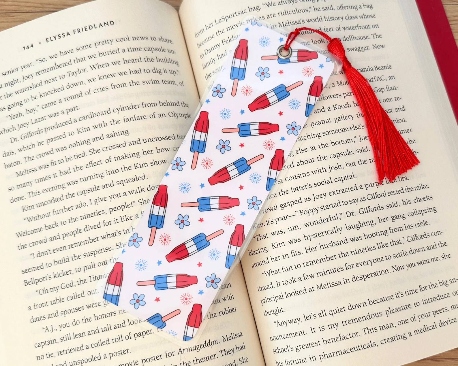 Image of a white bookmark with red, white, and blue bomb pops on it. 