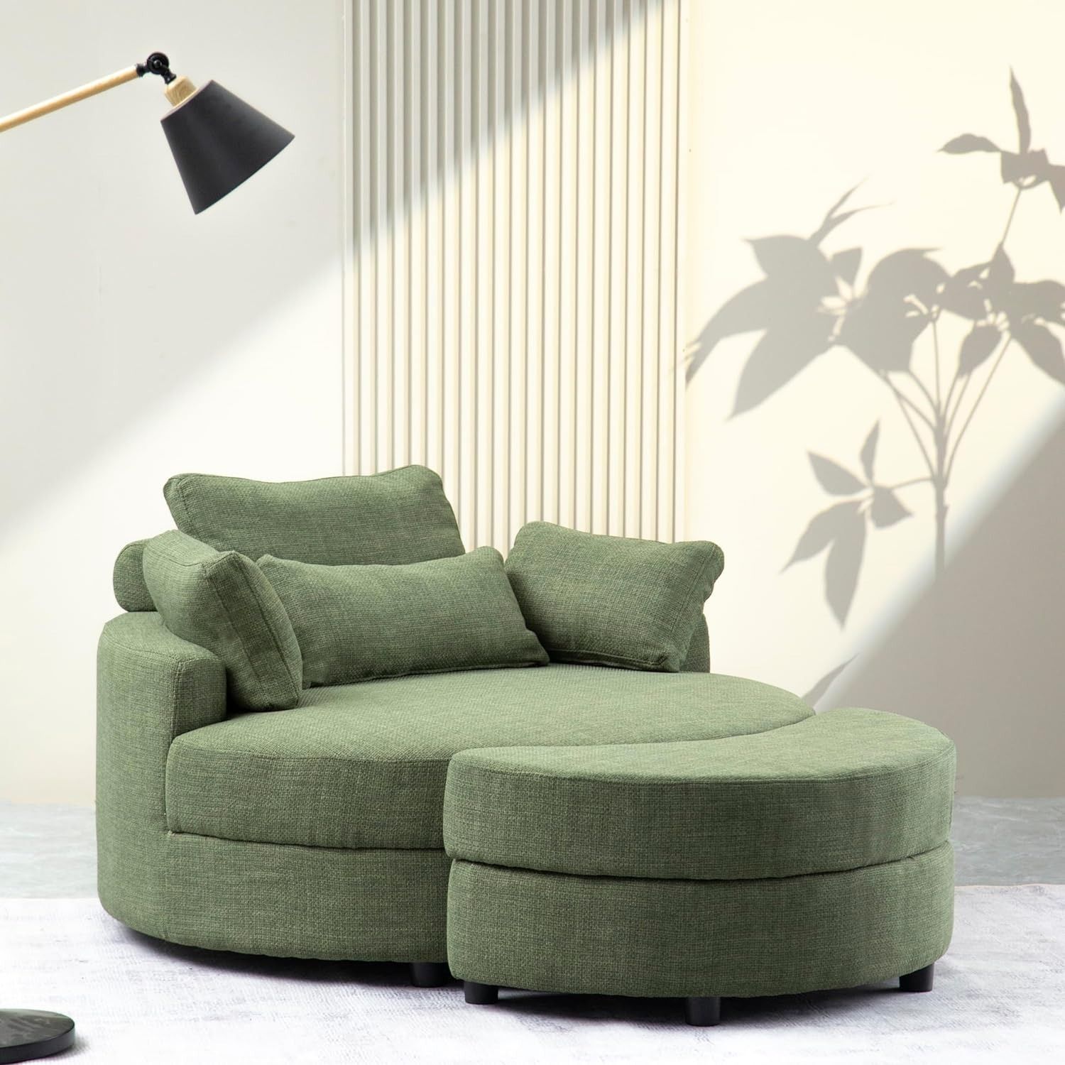 an oversized green round armchair with a matching half moon ottoman