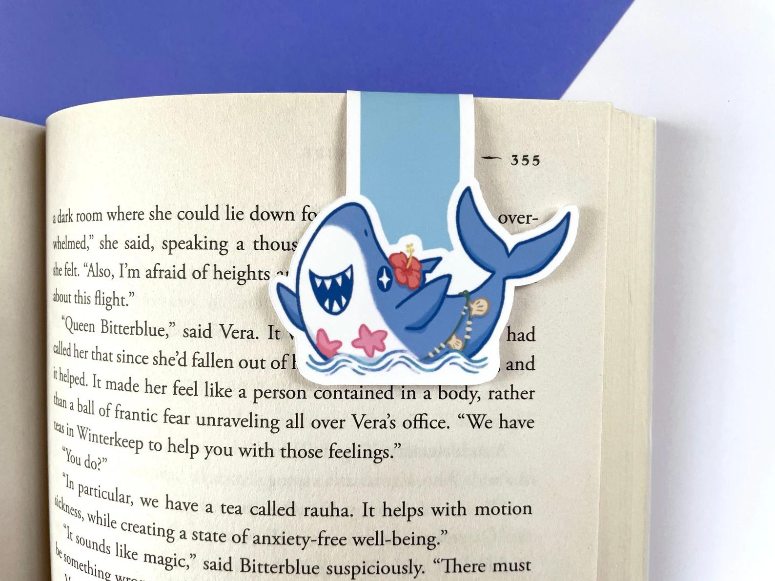 Image of a magnetic bookmark featuring a shark wearing a bikini. 