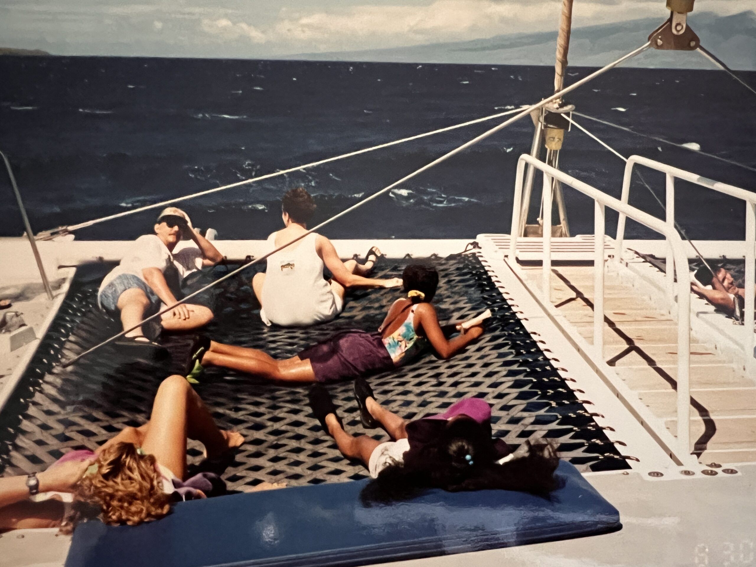 the author reads The New Boy on a pontoon boat in Hawaii