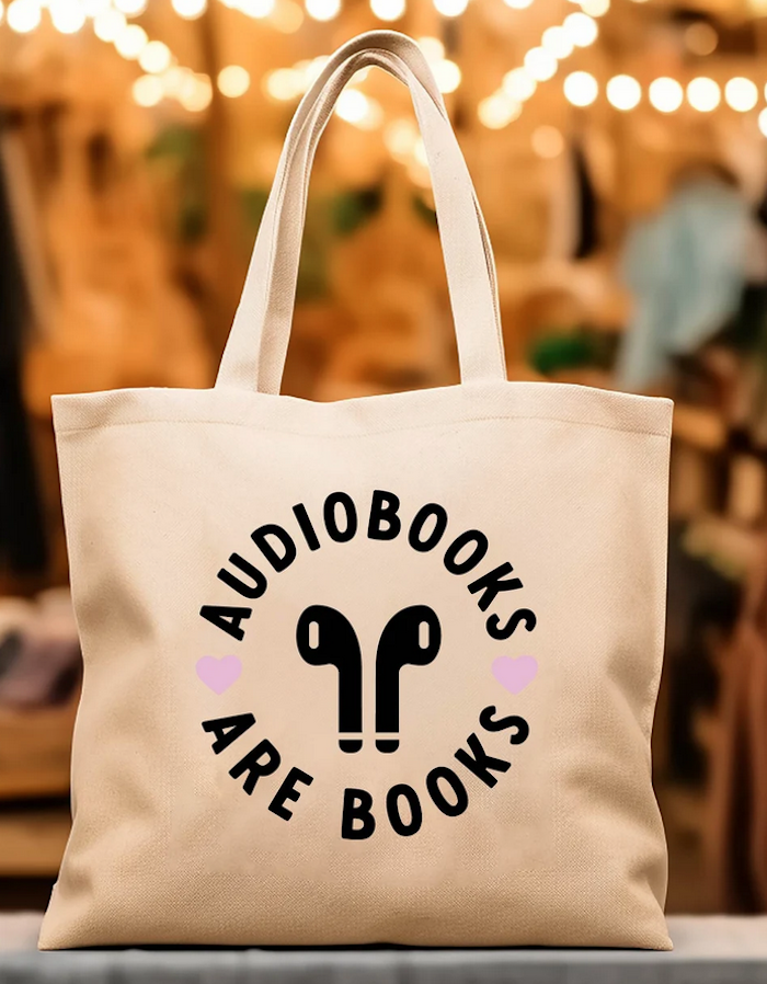 a tote bag that says "audiobooks are books" with earpods illustration