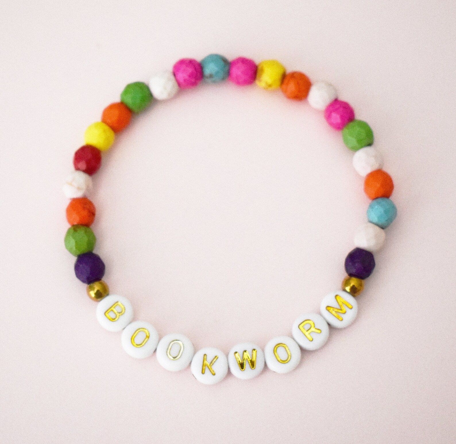 rainbow beaded bracelet with the letter beads spelling out bookworm. 