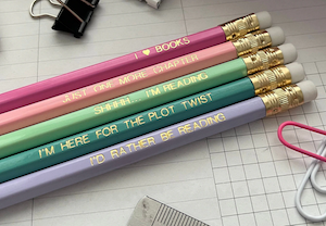 a set of pastel colored pencils with reading quotes etched in gold on them