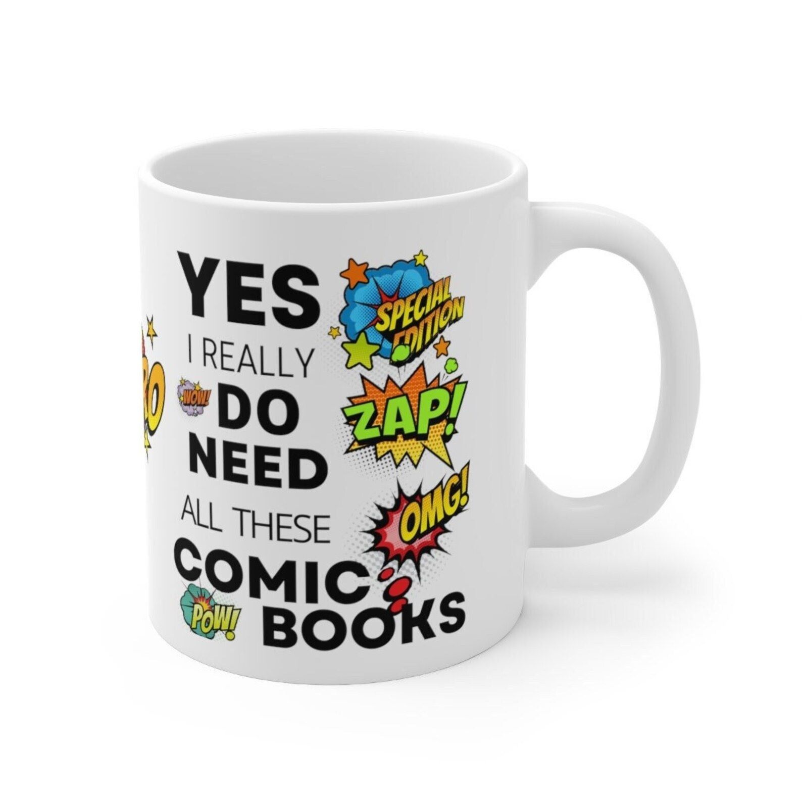 A white mug with onomatopoeias and black tex that says "Yes, I really do need all these comic books"