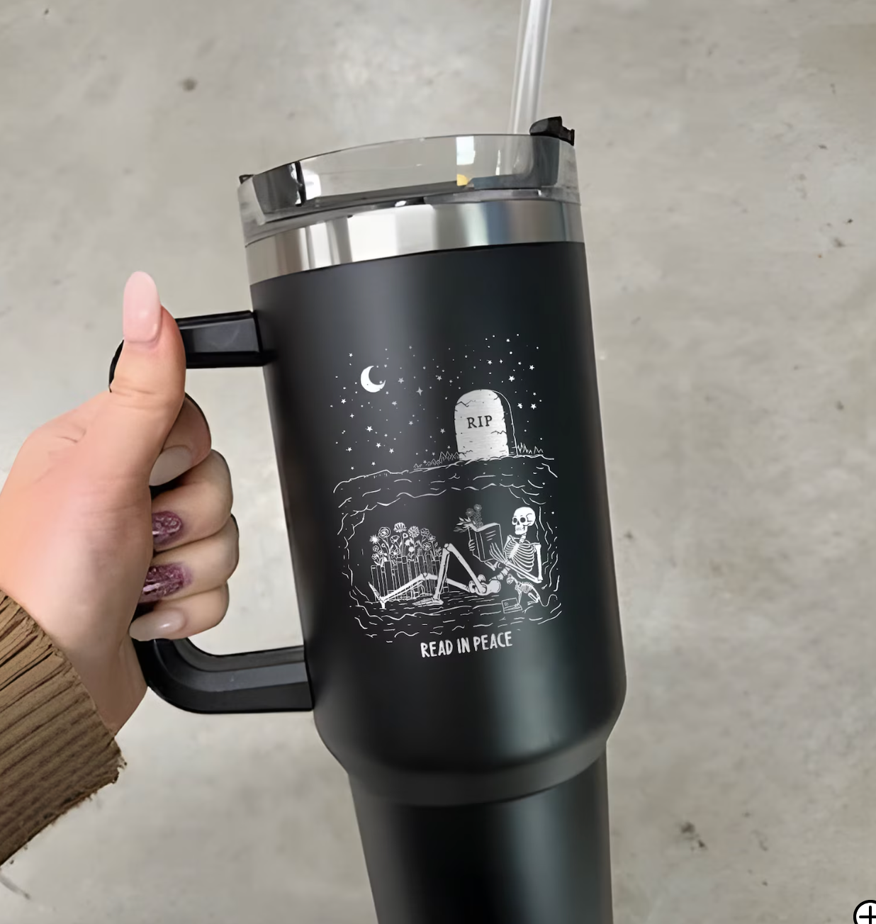 40 oz tumbler with an image of a skeleton under ground reading with the words "read in peace."