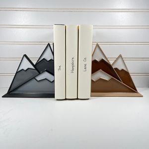 a photo of two mountain bookends made out of stained glass