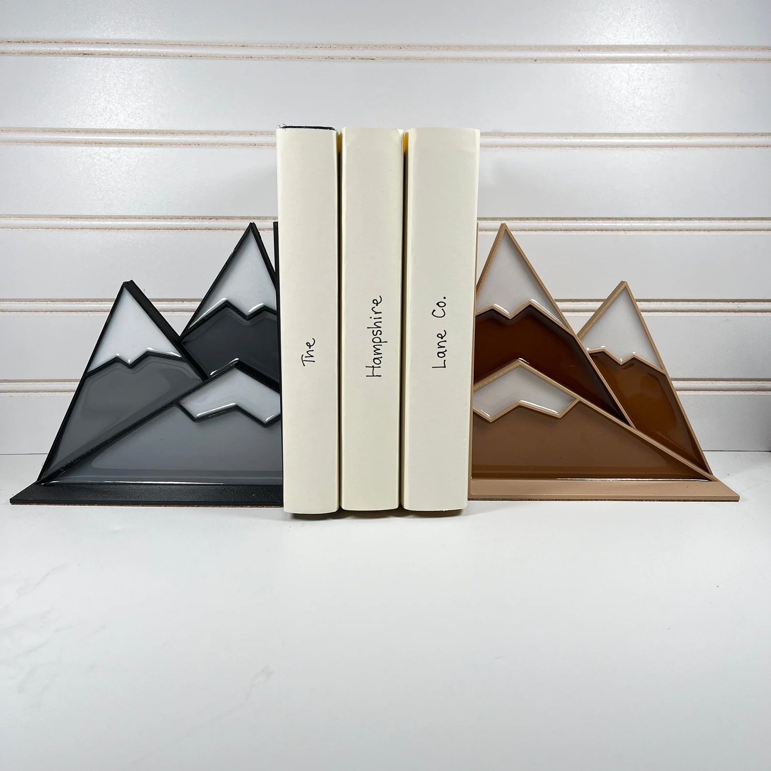 a photo of two mountain bookends made out of stained glass