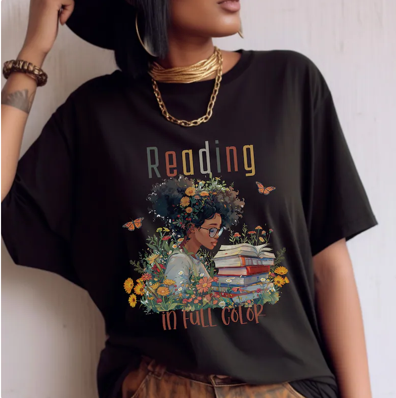 t shirt that says "reading in full color" with an illustrated Black woman reading on it