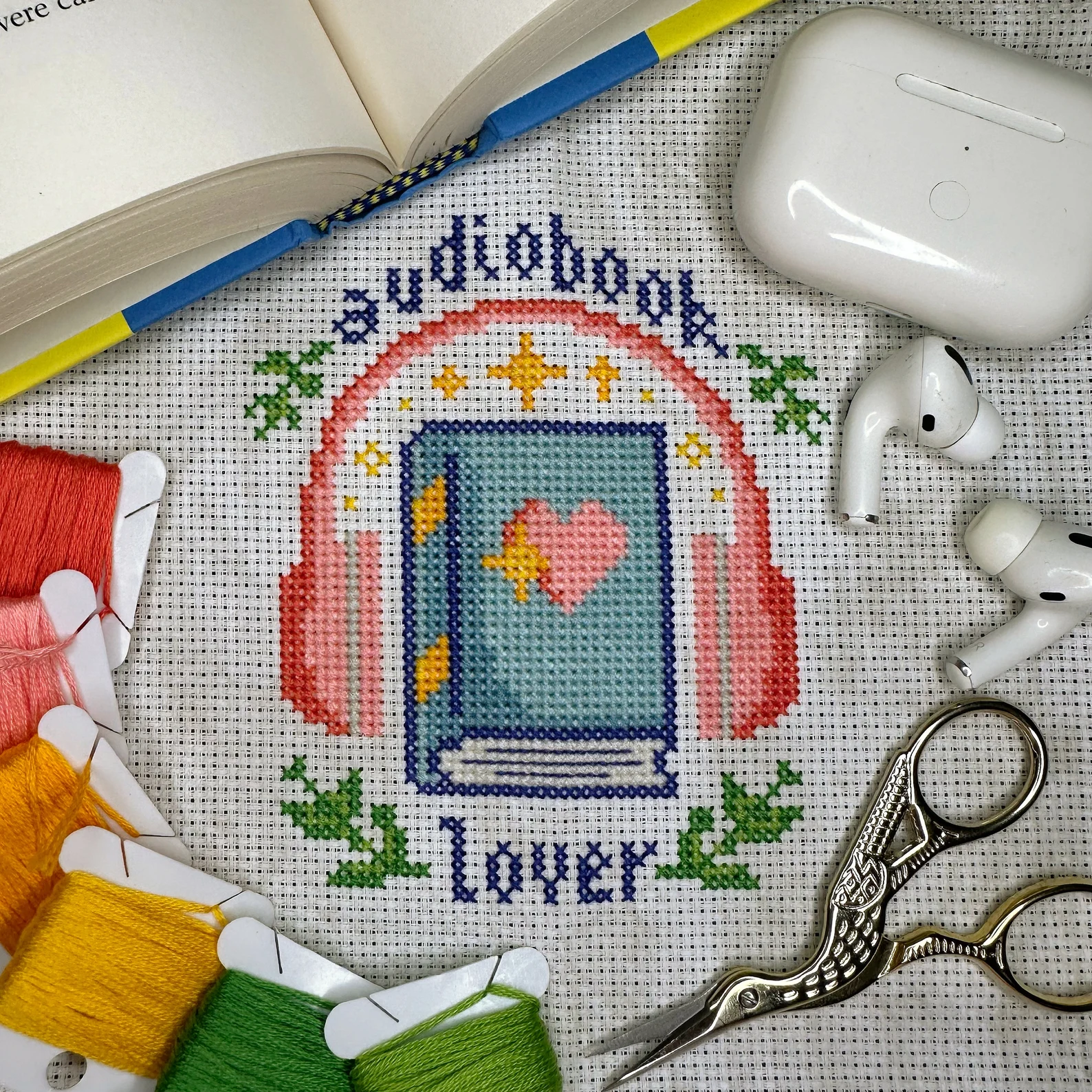 Image of a cross stitch that says "audiobook lover."