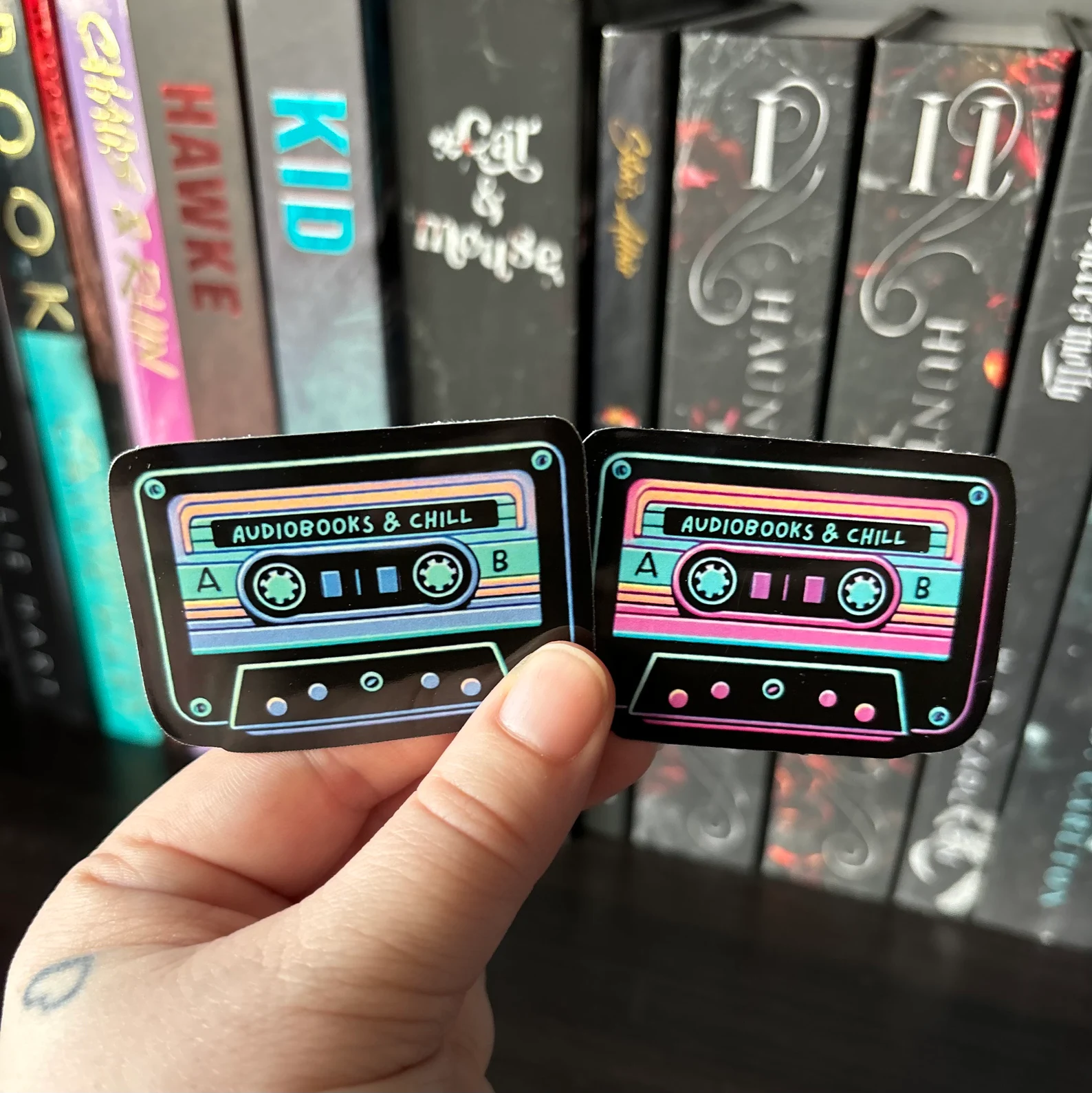 two stickers that look like black cassette tapes and read "audiobooks and chill."