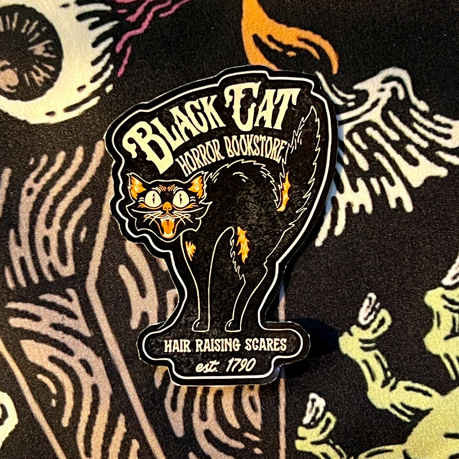 image of a sticker that is in the shape of a black cat. 