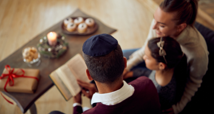 a photo of a Jewish family reading together