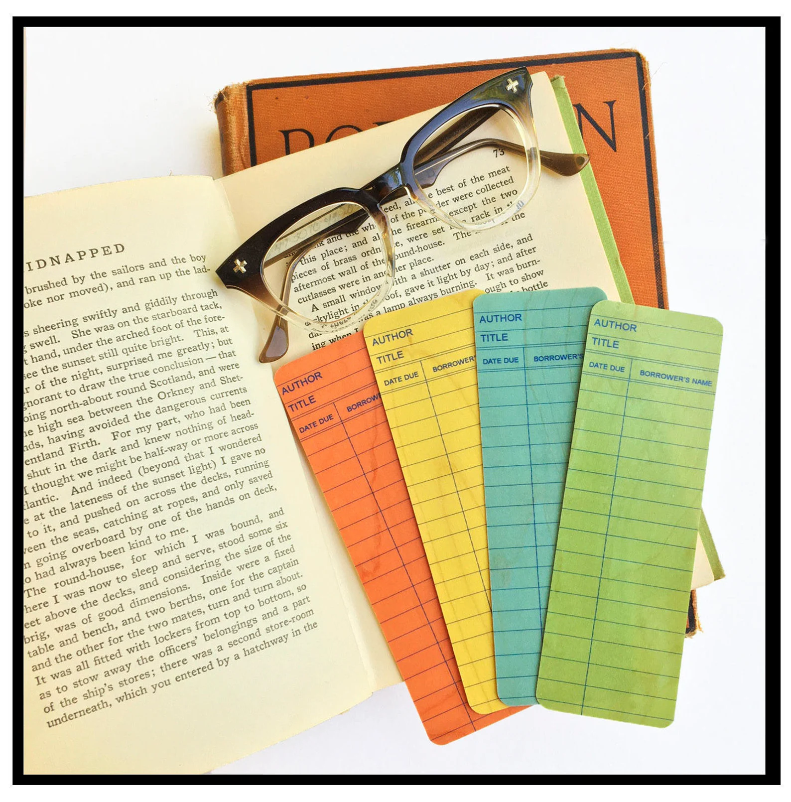 image of four wooden bookmarks on an open book.