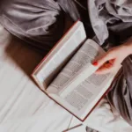 a photo of a person reading in bed