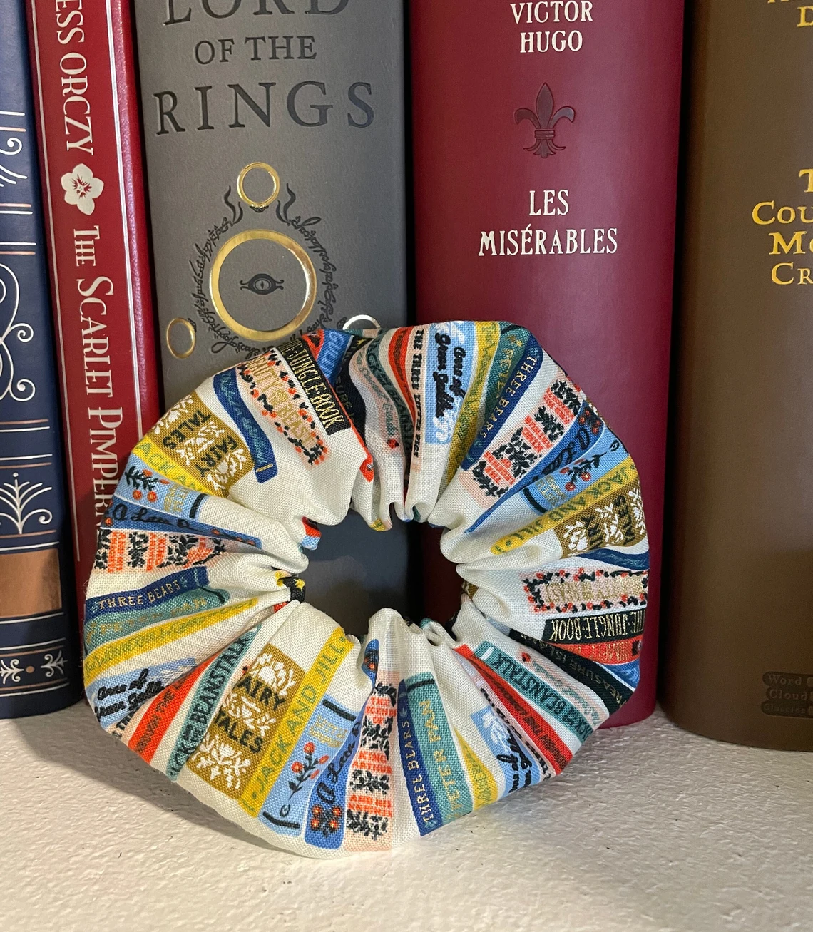 Book scrunchie made of cream fabric with book spines