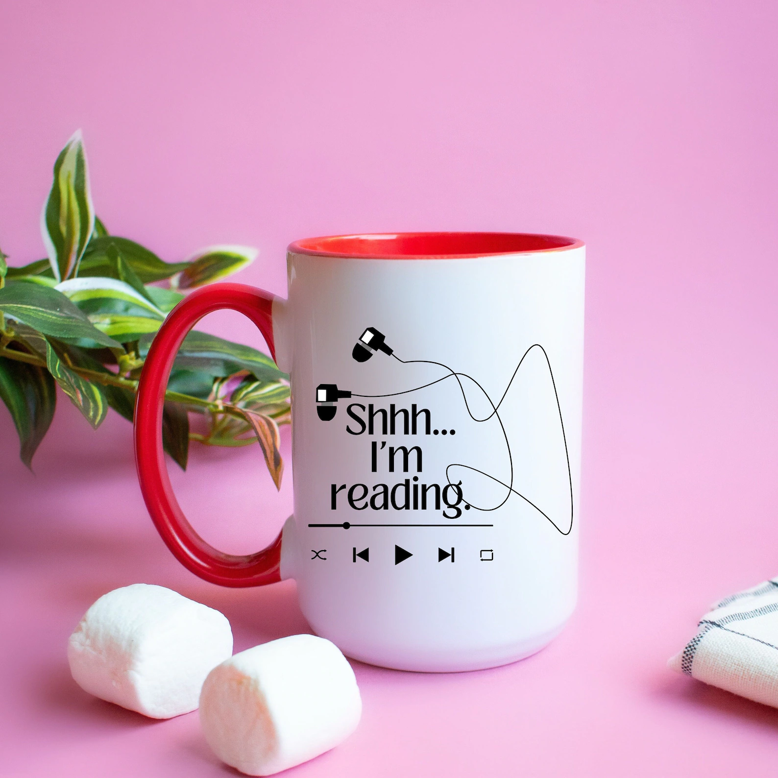 Image of a white mug with an image of headphones and the words "shhh...I'm reading."