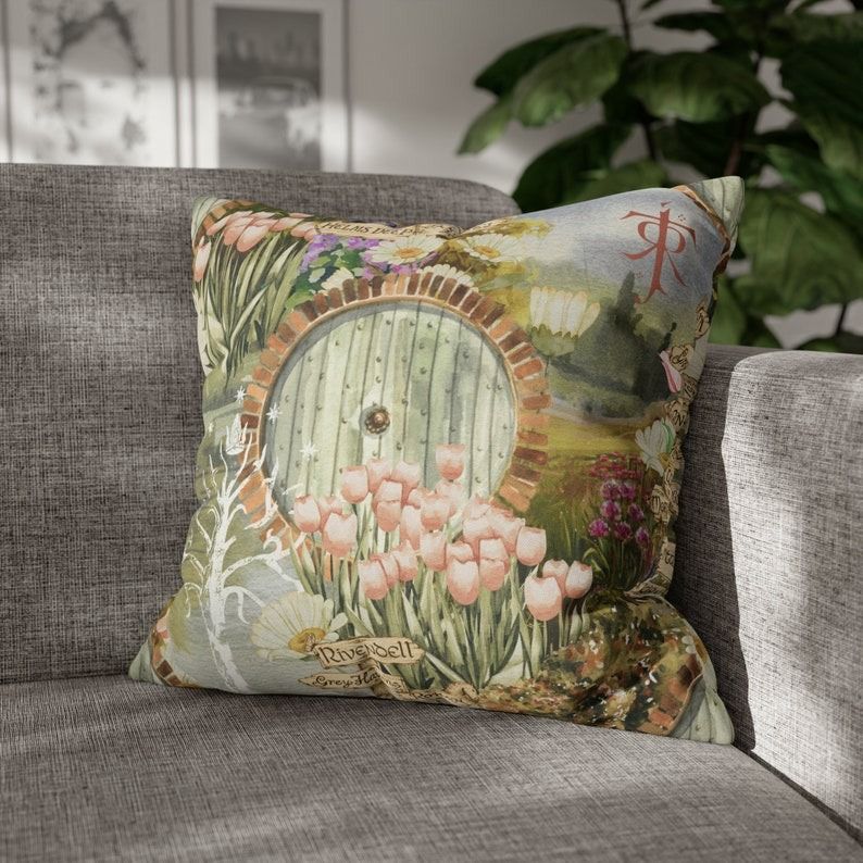 an illustration of flowers and a hobbit hole on a pillow