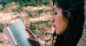 tan-skinned woman reading a book