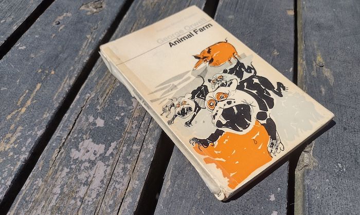 a used copy of Animal Farm held together with tape