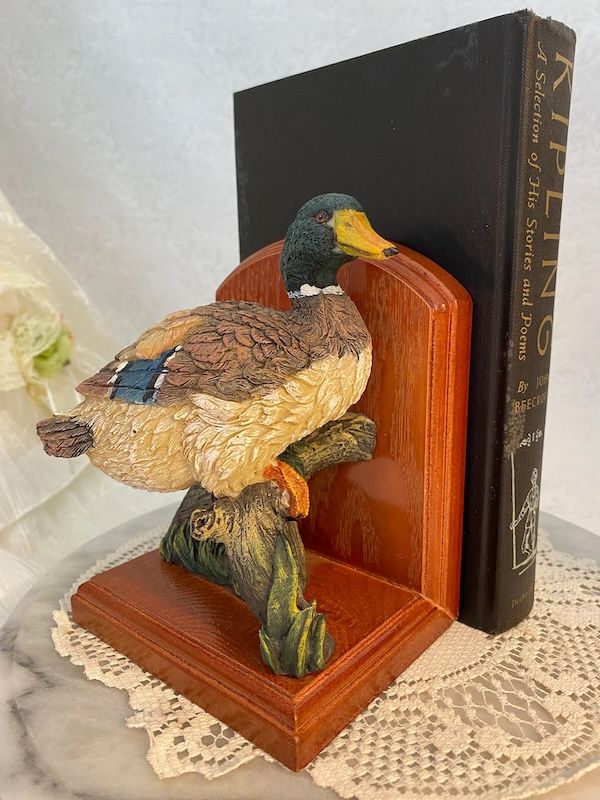 a single book end with a resin mallard duck and a wooden base
