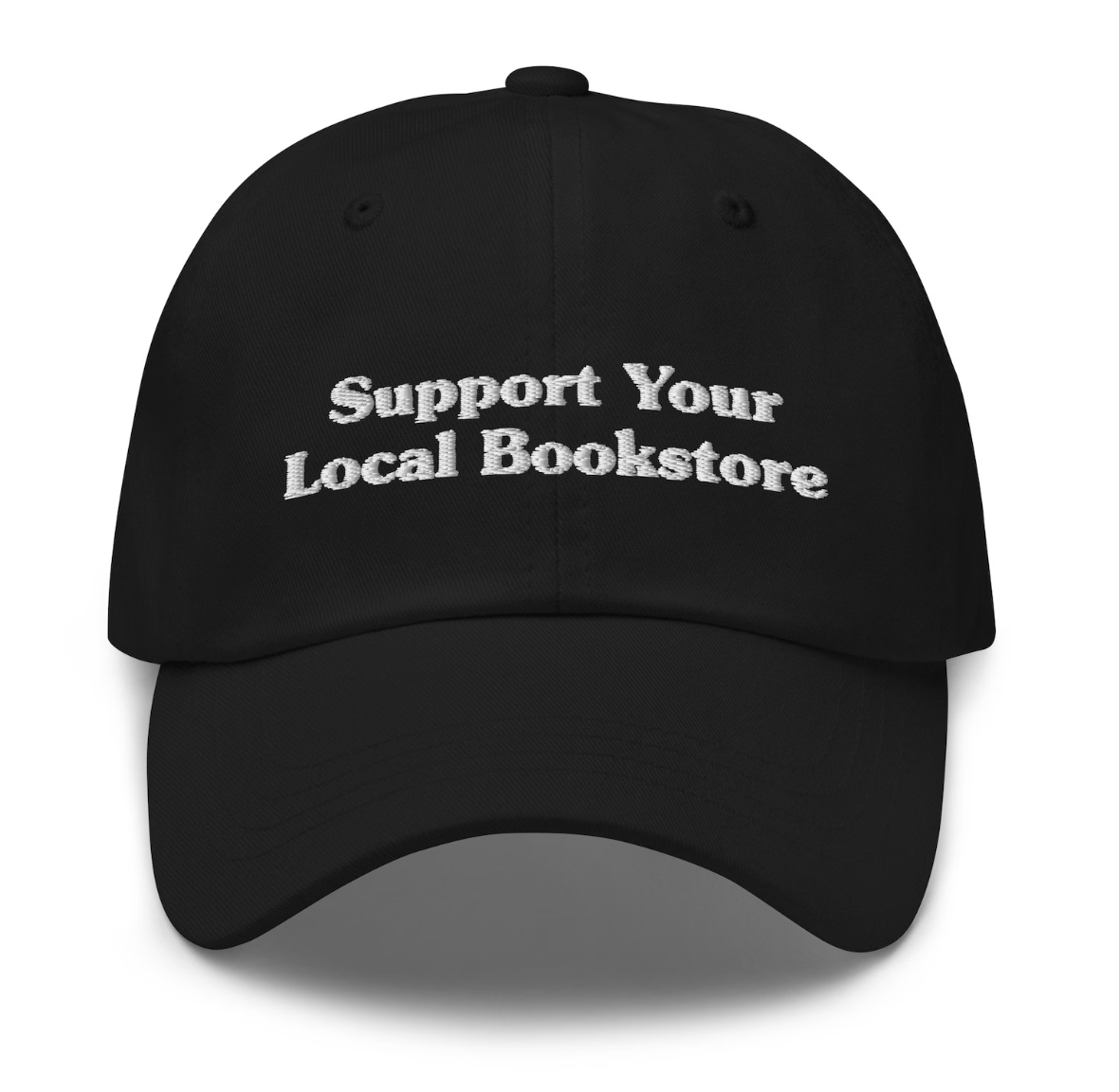 Image of a black baseball hat with the phrase "support your local bookstore" embroidered in white