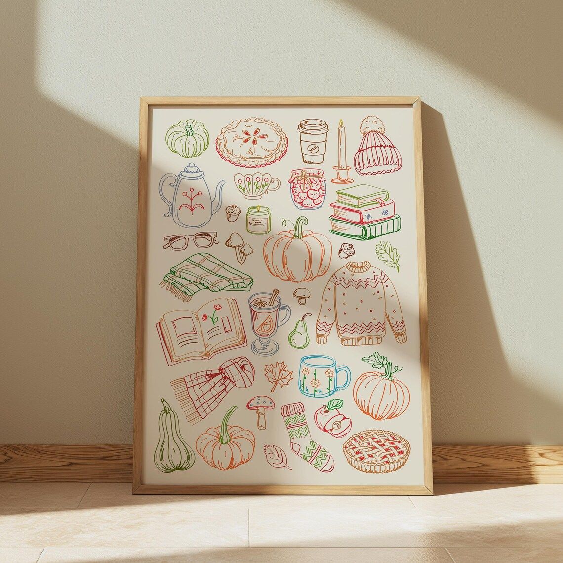 Colorful print with line drawings of books, pumpkins, coffee, and sweaters in autumn colors.