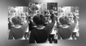 grayscale image of a Black woman with her fist raised in protest