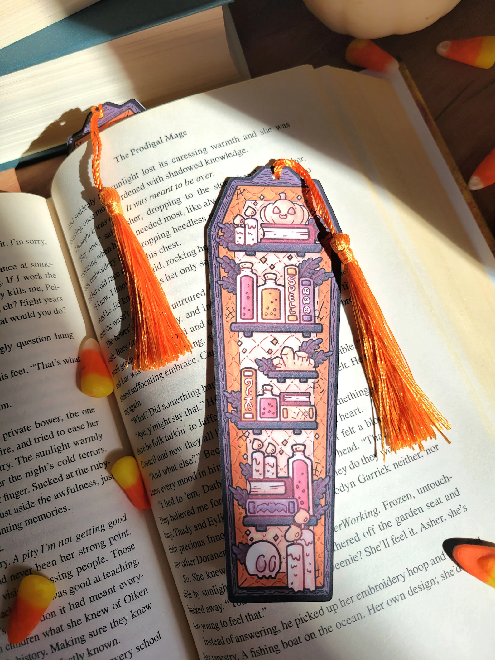 Image of a bookmark in the shape of a coffin filled with books. 