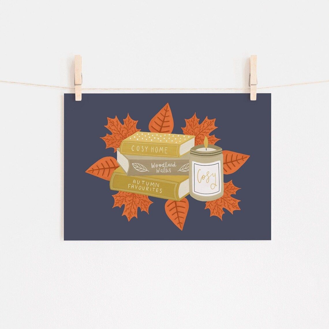 Blue background with three books, a candle, and orange leaves in the center.