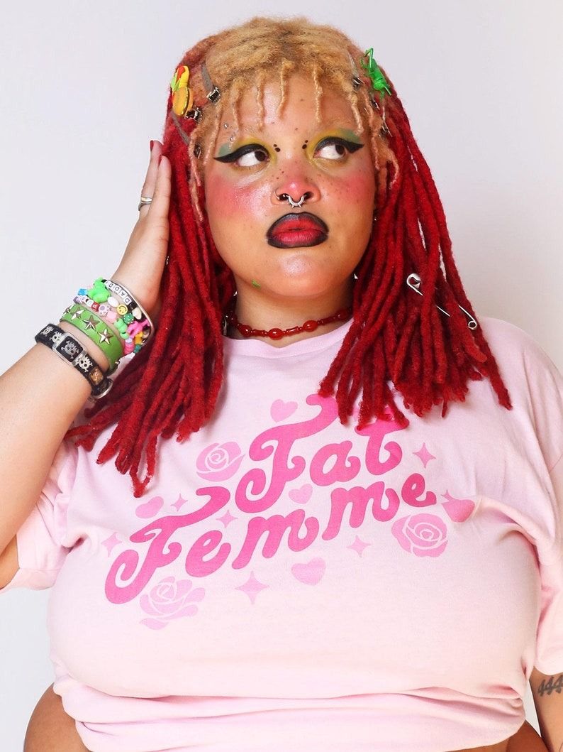 a photo of a fat Black person wearing a shirt that says 