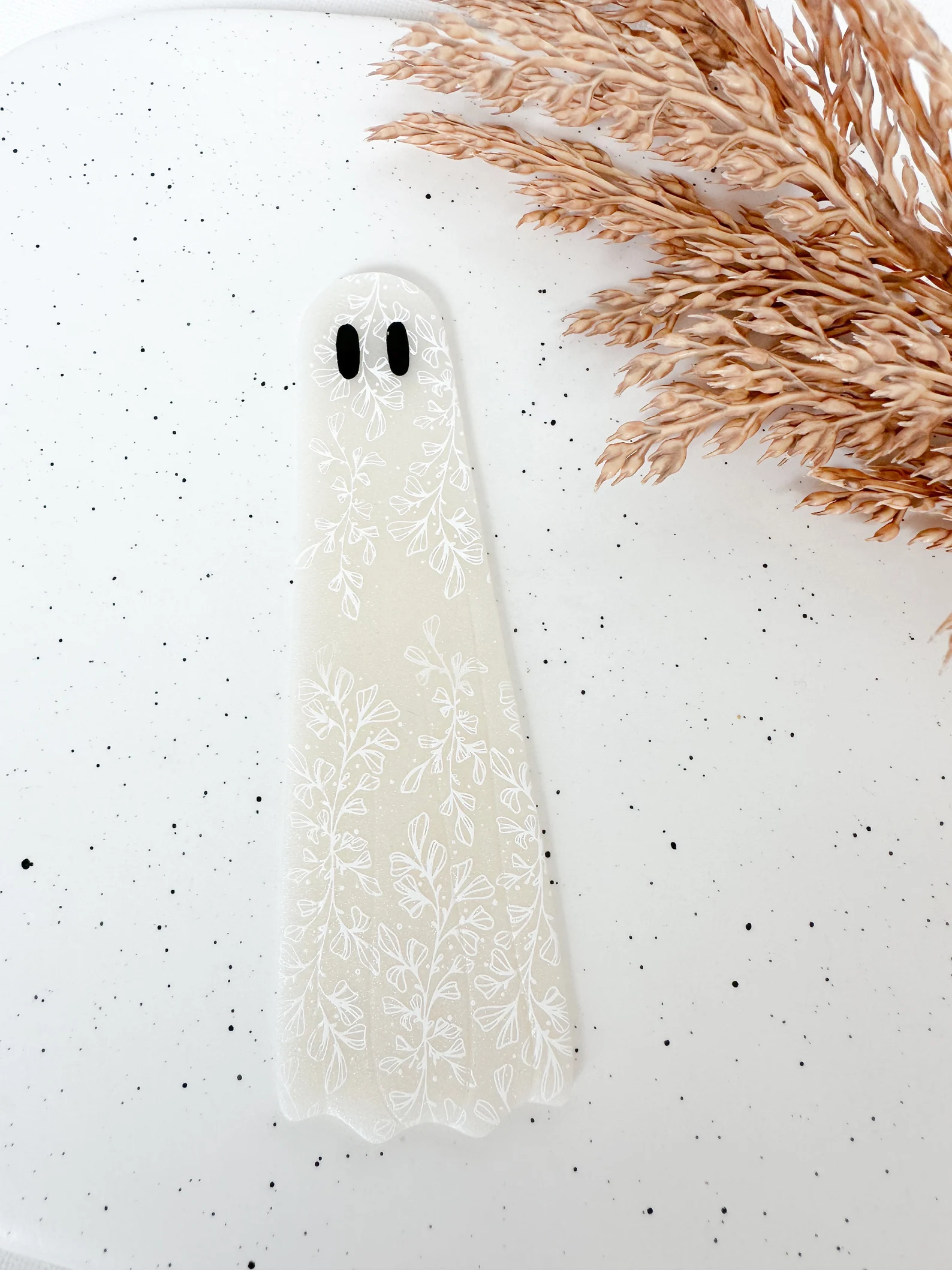 Image of a white bookmark in the shape of a ghost.