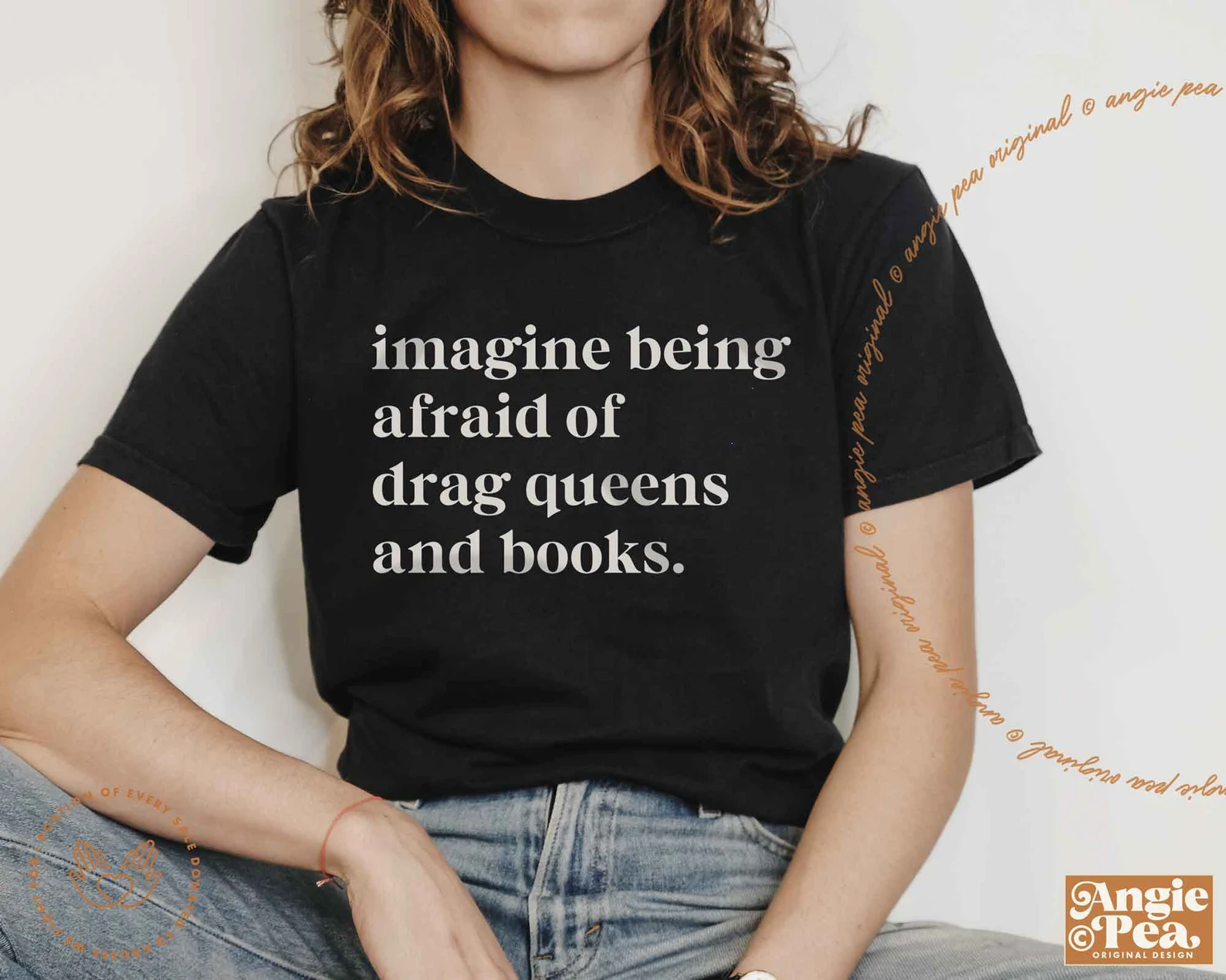 Image of a black tshirt that says in white font "imagine being afraid of drag queens and books."