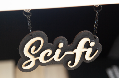 laser cut wooden sign on a chain reading 'Sci-fi'