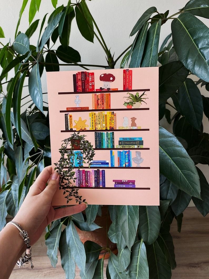 a print of a bookshelf with the books in rainbow arrangement