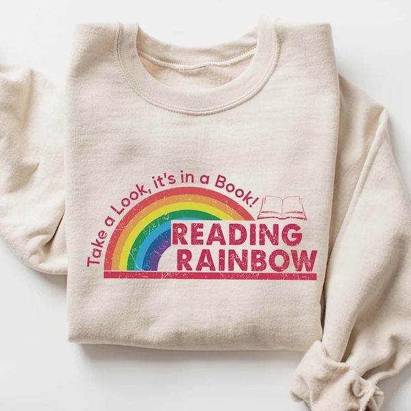 cream crewneck sweater with the Reading Rainbow logo 