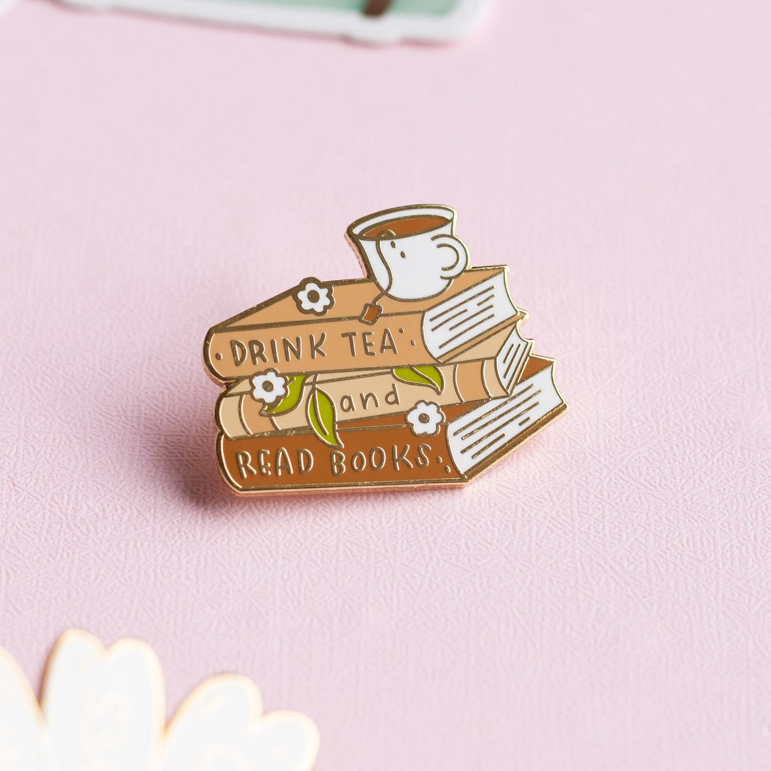 a photo of an enamel pin that reads 