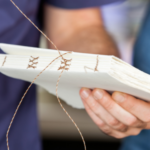 someone sewing pages as part of bookbinding