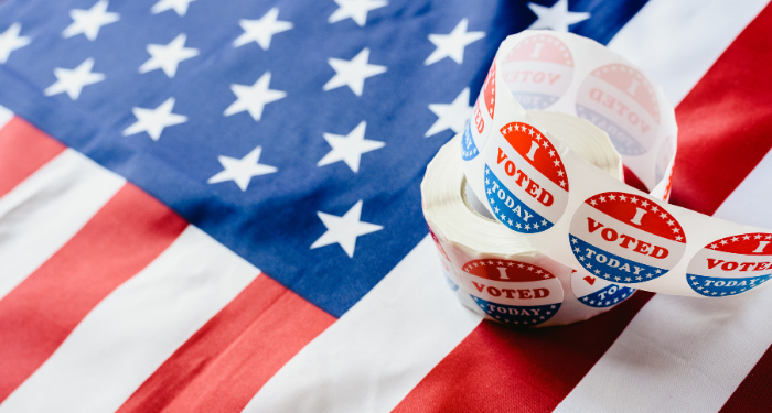 a roll of "I voted today" stickers on an American flag