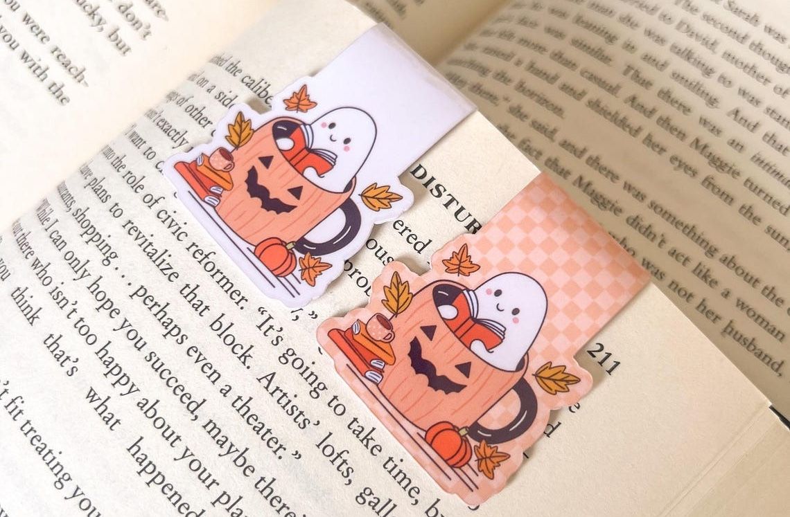 magnetic bookmark of a reading hosts in a jack-o-lantern mug