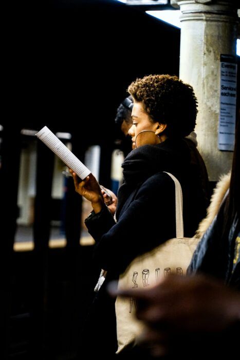 Woman reading in subway station