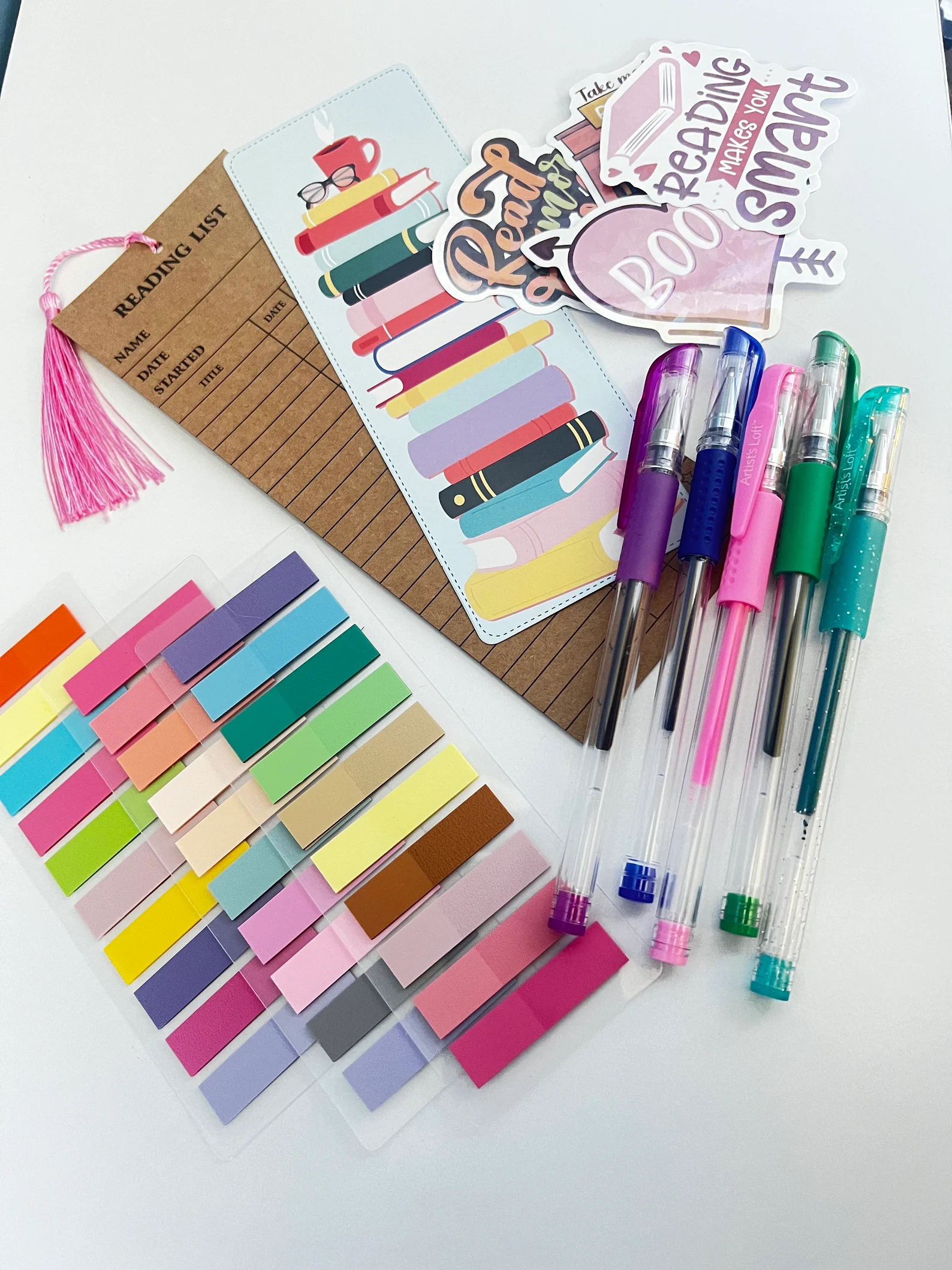 Image of a book annotating kit that includes a bookmark, a reading log, stickers, pens, and sticky page flags. 