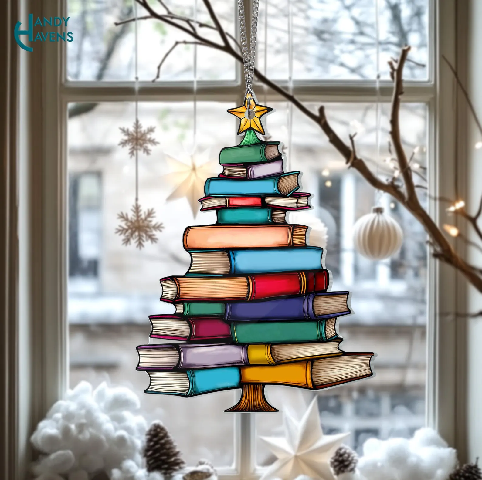 Image of a suncatcher in the shape of a christmas tree made out of books. 