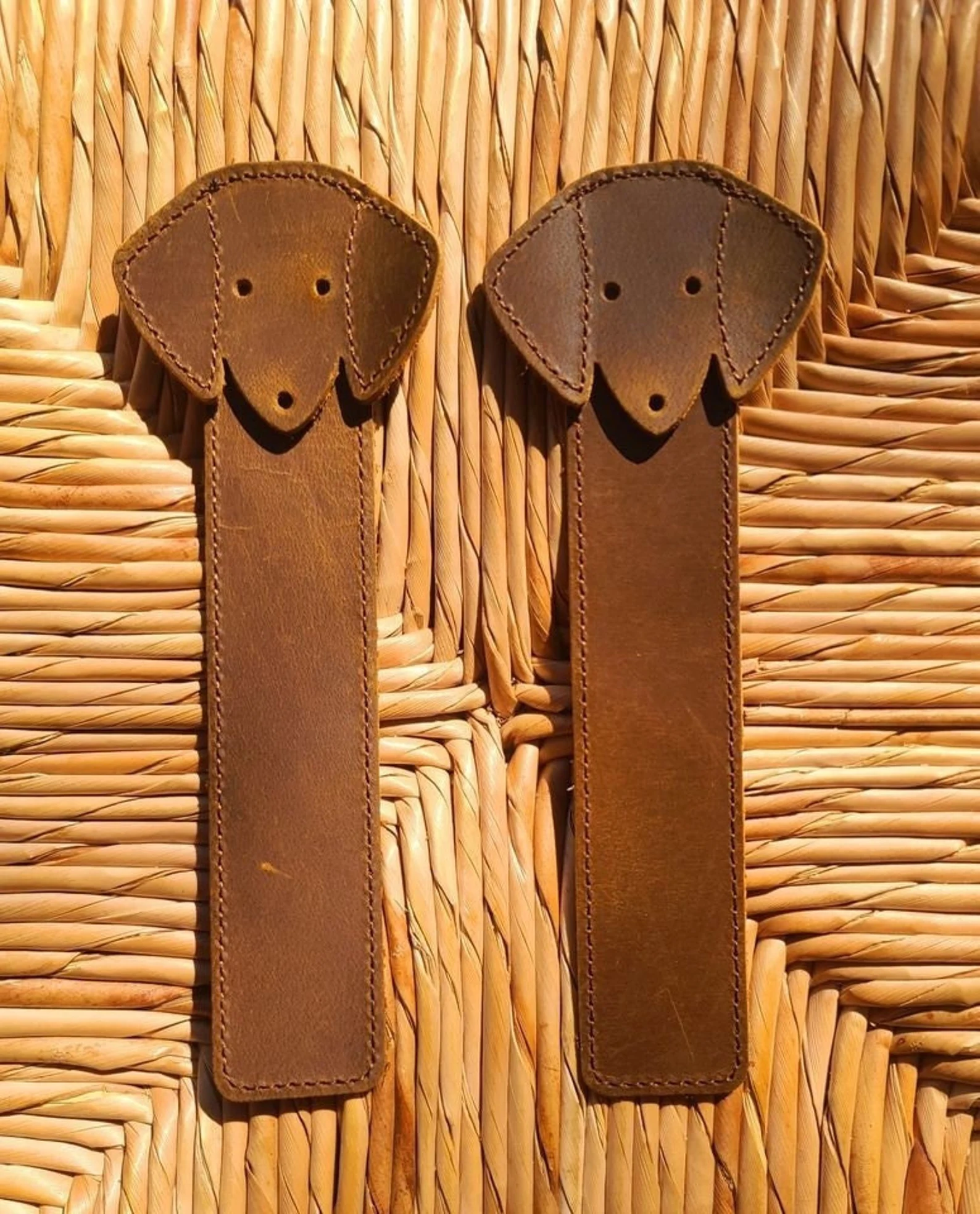 Two leather bookmarks in the shape of dachshunds.