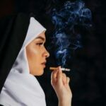 fair-skinned nun smoking