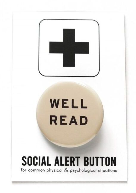 round cream button with black modern lettering that says "well read." 