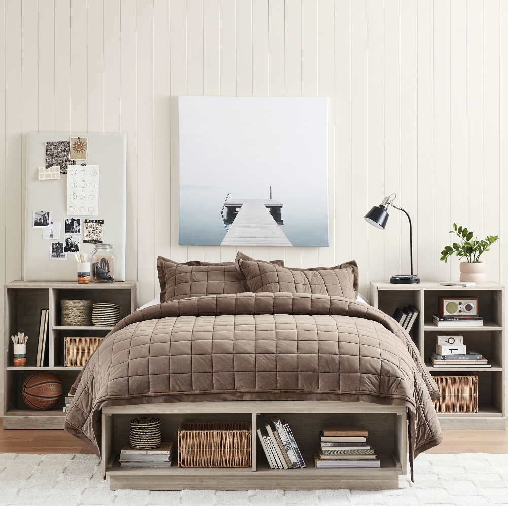 Photo of a Pottery Barn bedset with bookshelves on either side and bookshelves built in under the mattress