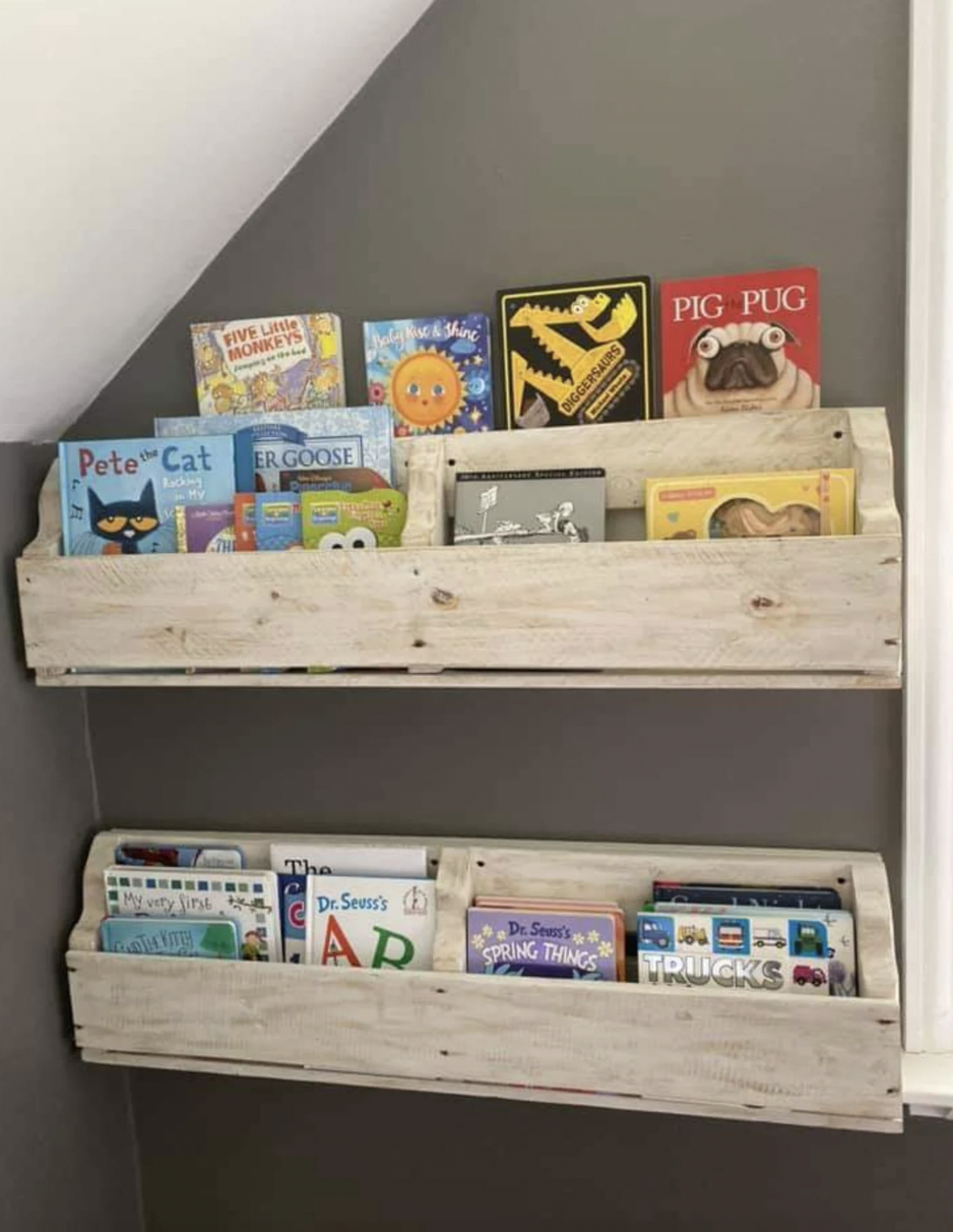 Photo of two pieces of reclaimed wooden pallets hung on a wall and used as bookshelves