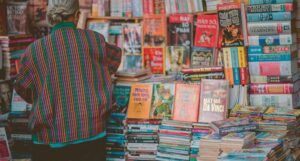 a person with gray hair looks at books